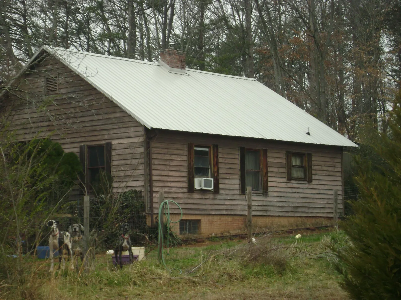 White metal roof on an old wood sided farmhouse, from a Asphalt Shingle Roof Repair job in Liverpool